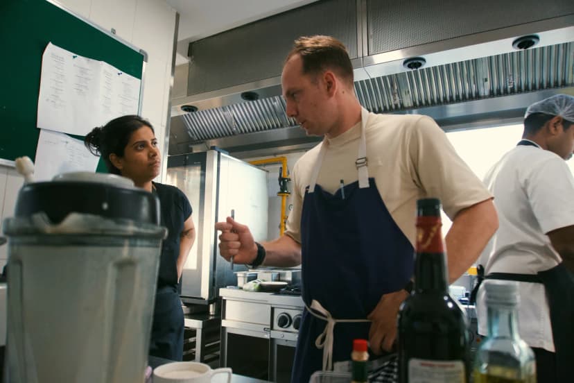 Jason talking with a chef during prep in Hyderabad