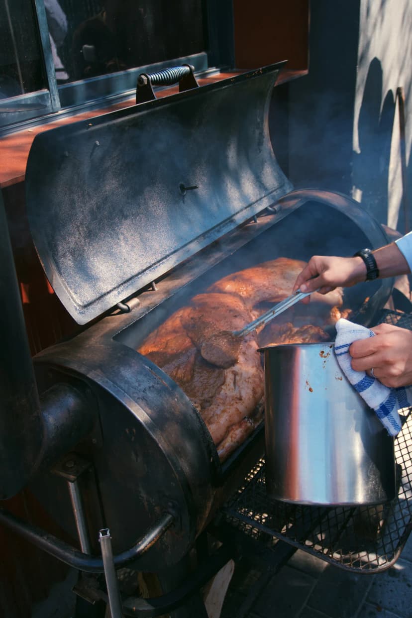 Meat cooking over the smoky outdoor grill at Kruger Shalati