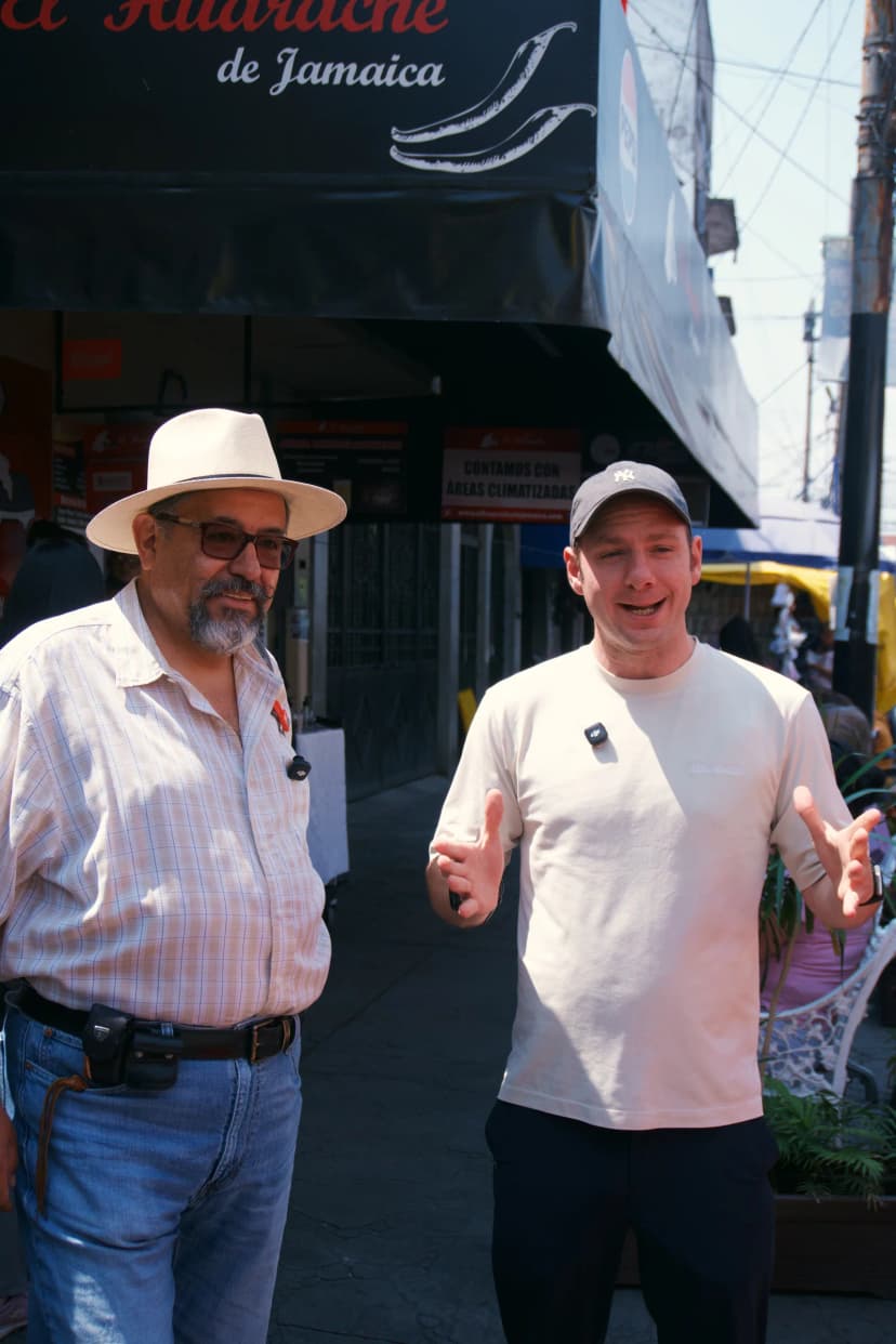 Jason and Paco standing outside a food stop in Mexico City